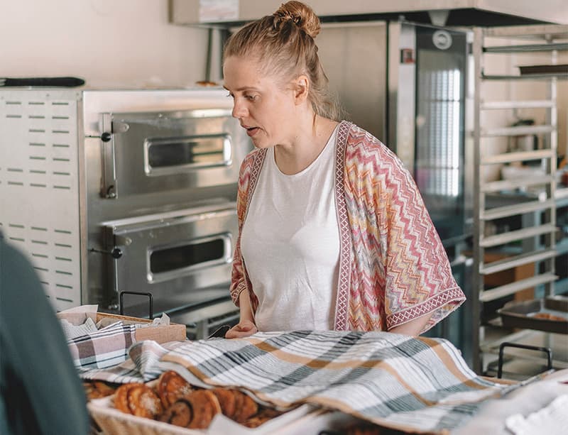 A bakery owner reviews orders on a tablet